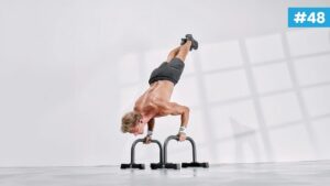 Athlète réalisant un HSPU, handstand push-up contre un mur, bras tendus